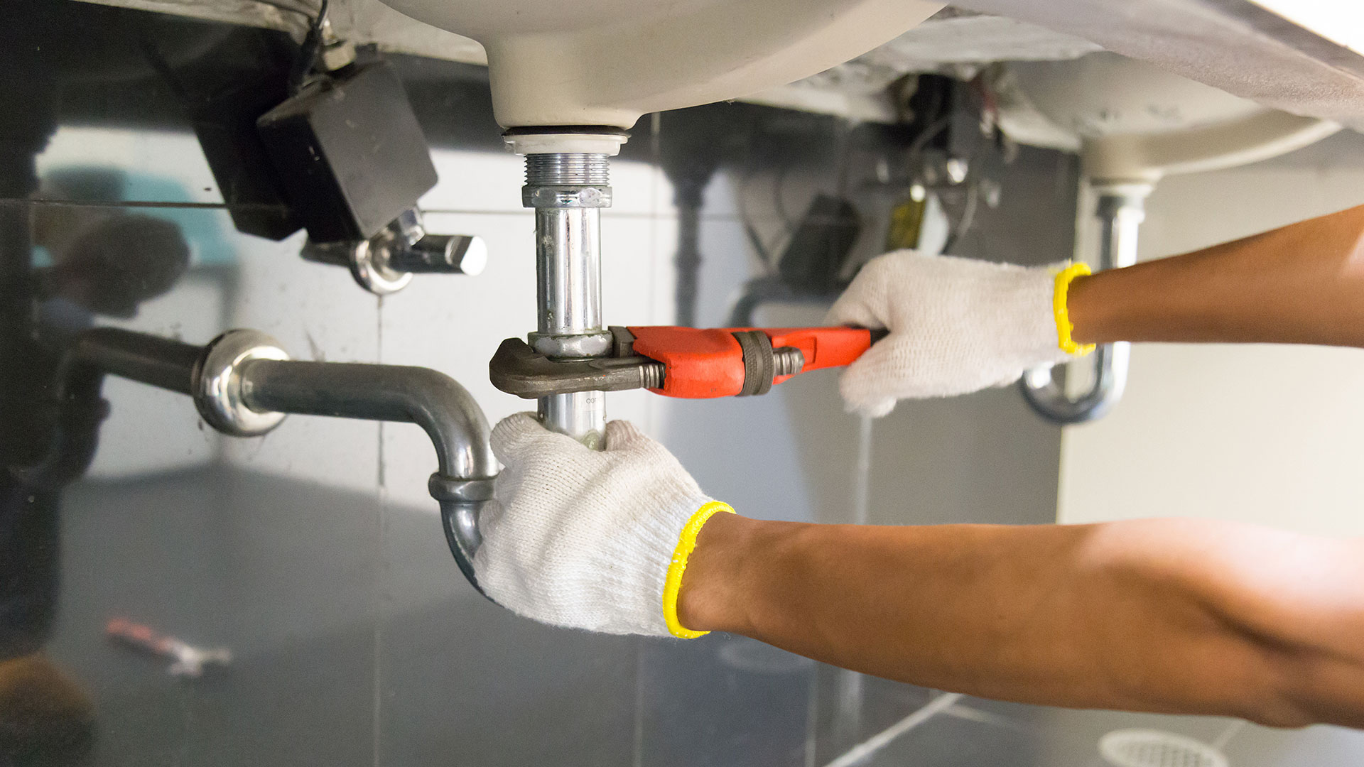 the picture shows the repair of a sink faucet